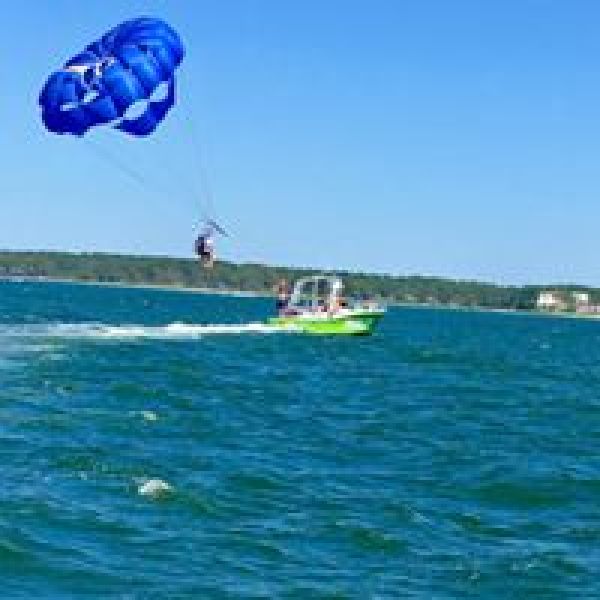 A blue parasail being released from the boat