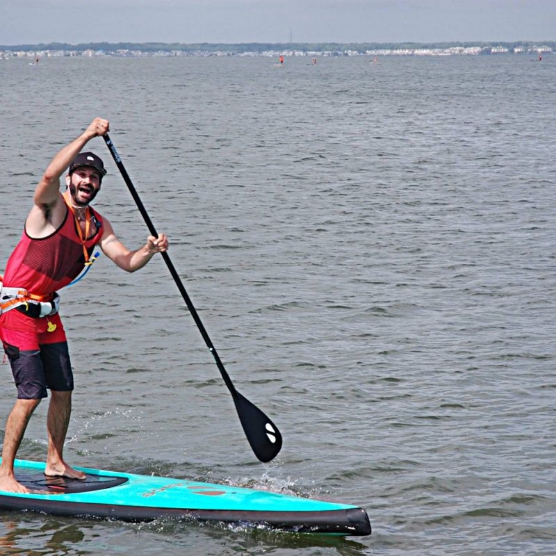 A paddle boarder paddling far from shore